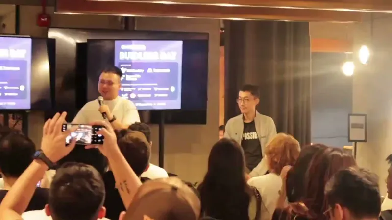 Speakers on stage before a full audience