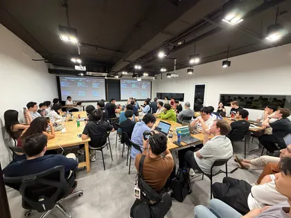 Attendees working on laptops at long tables during OpenClaw Builders Bangkok